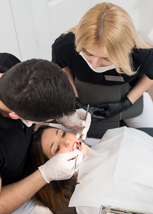 A dentist working with a patient.